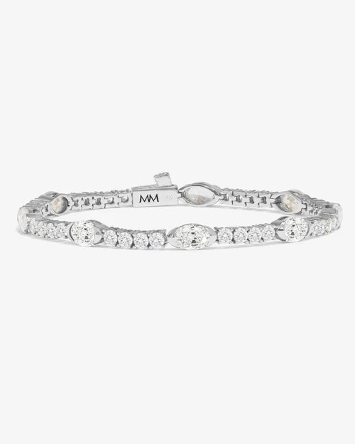Maven tennis bracelet with horizon half bezel setting and open side stones