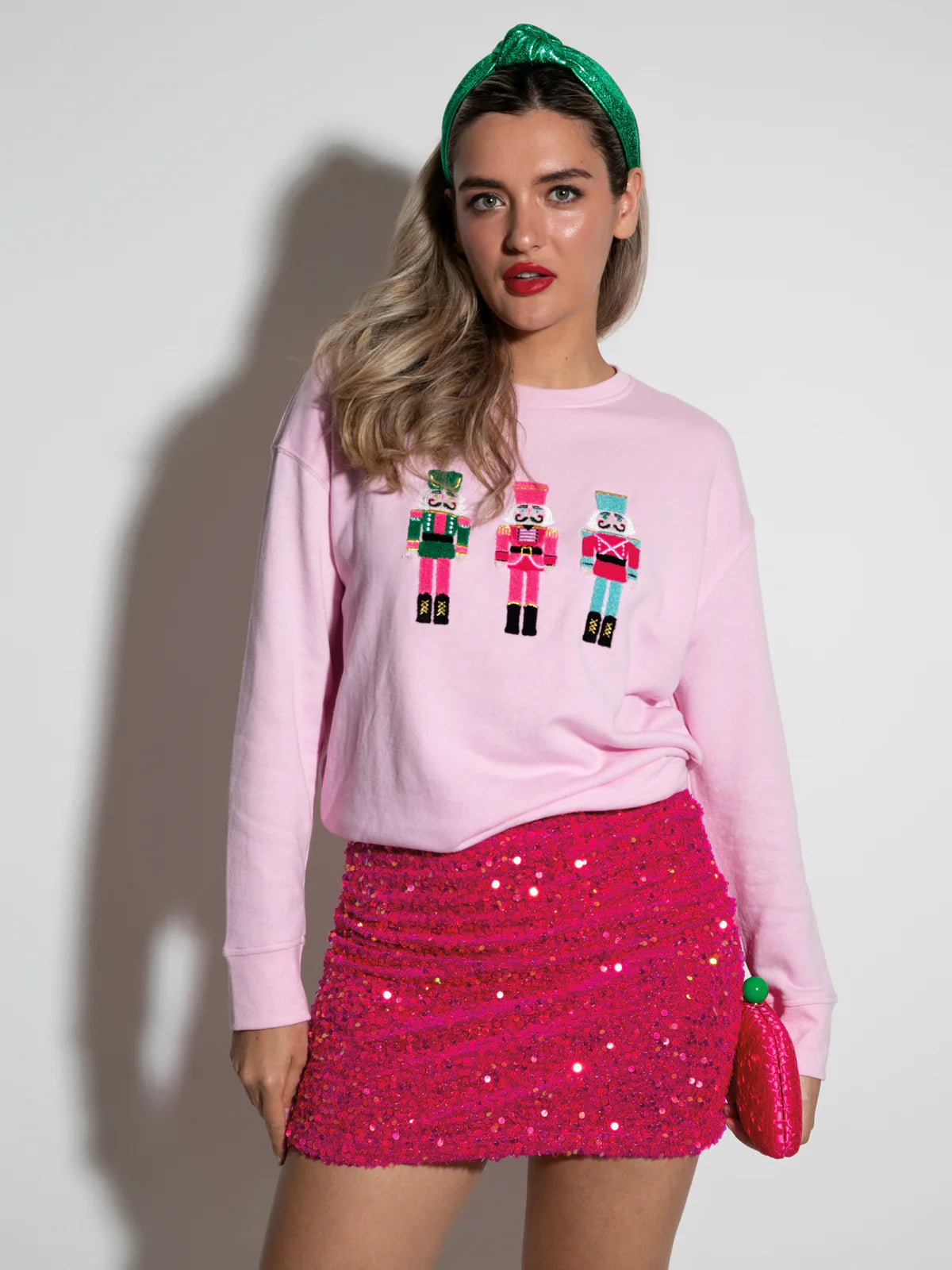 Shiraleah Nutcracker pink sweatshirt with embroidered nutcracker icons